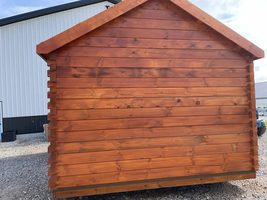 The Cub’s gable end wall of stained pine logs