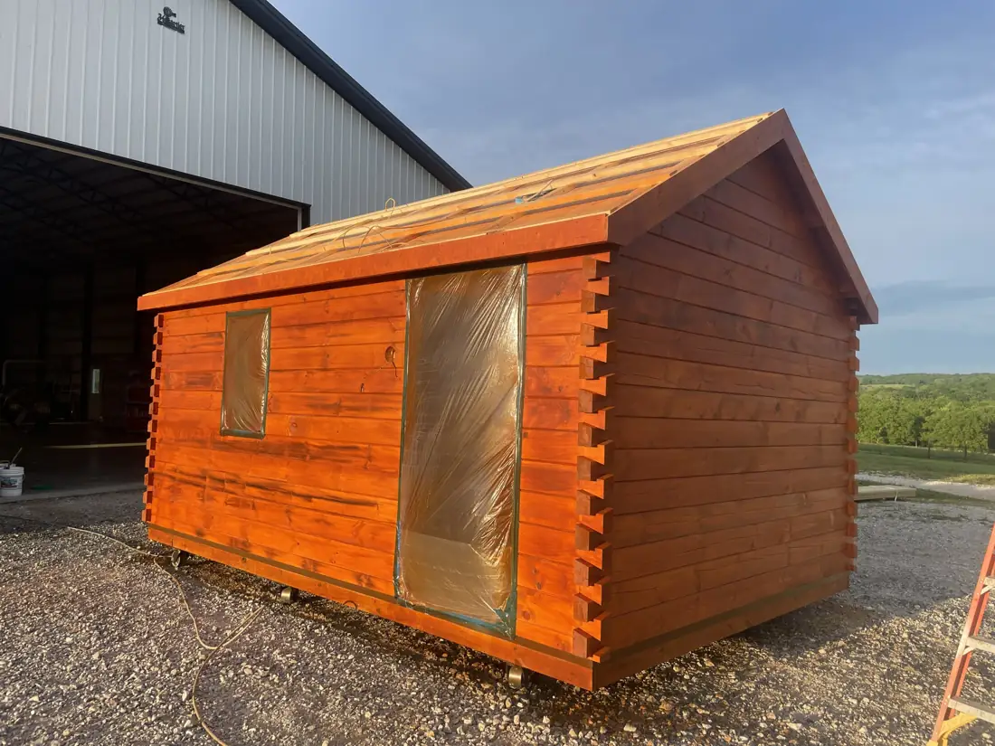Log walls and roof framing on The Cub before the door goes in