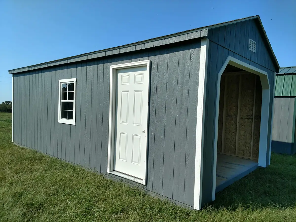 Gray utility garage with a side entry door, window and open garage bay