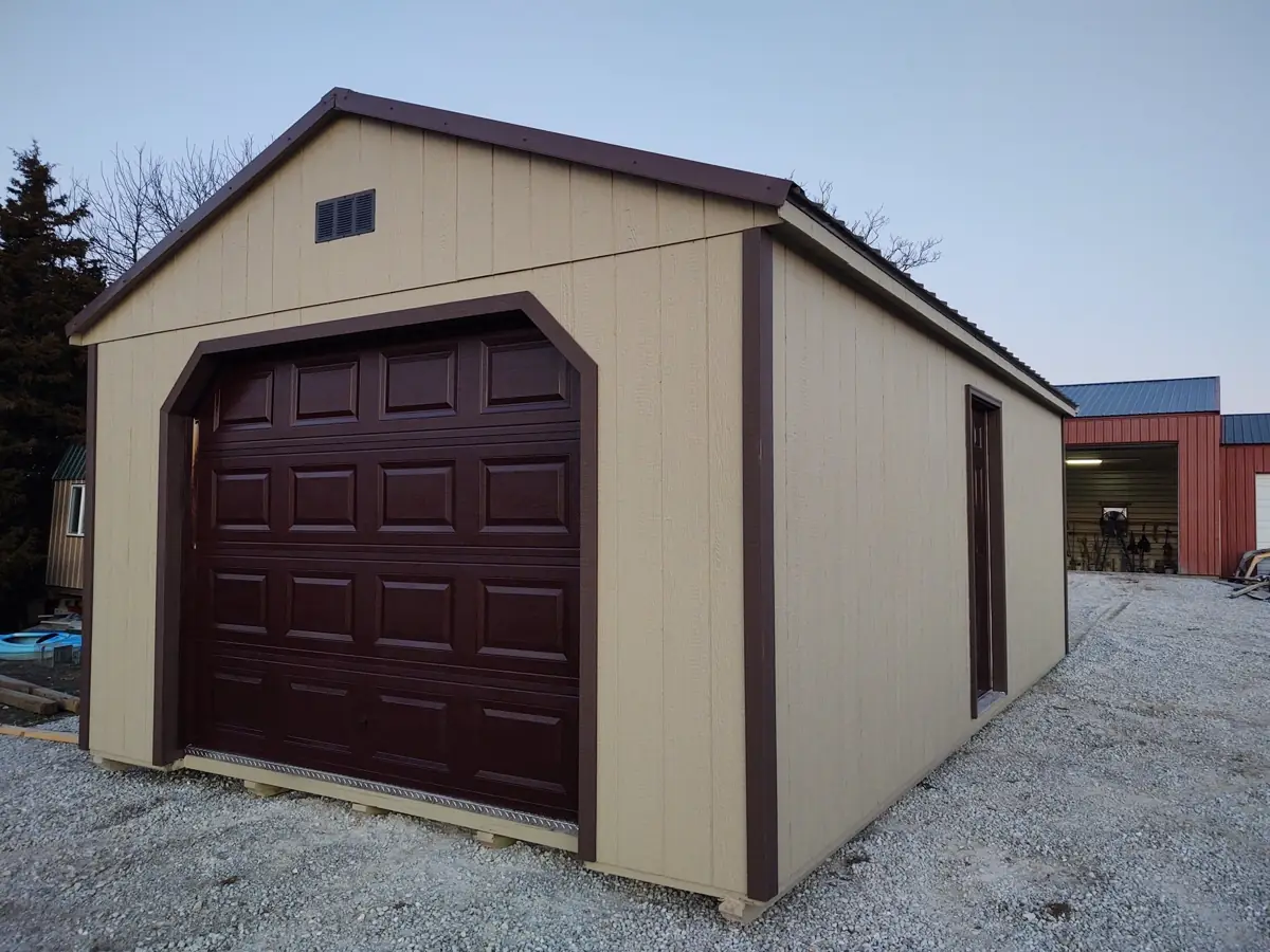 Tan utility garage with a dark brown roll-up door and trim