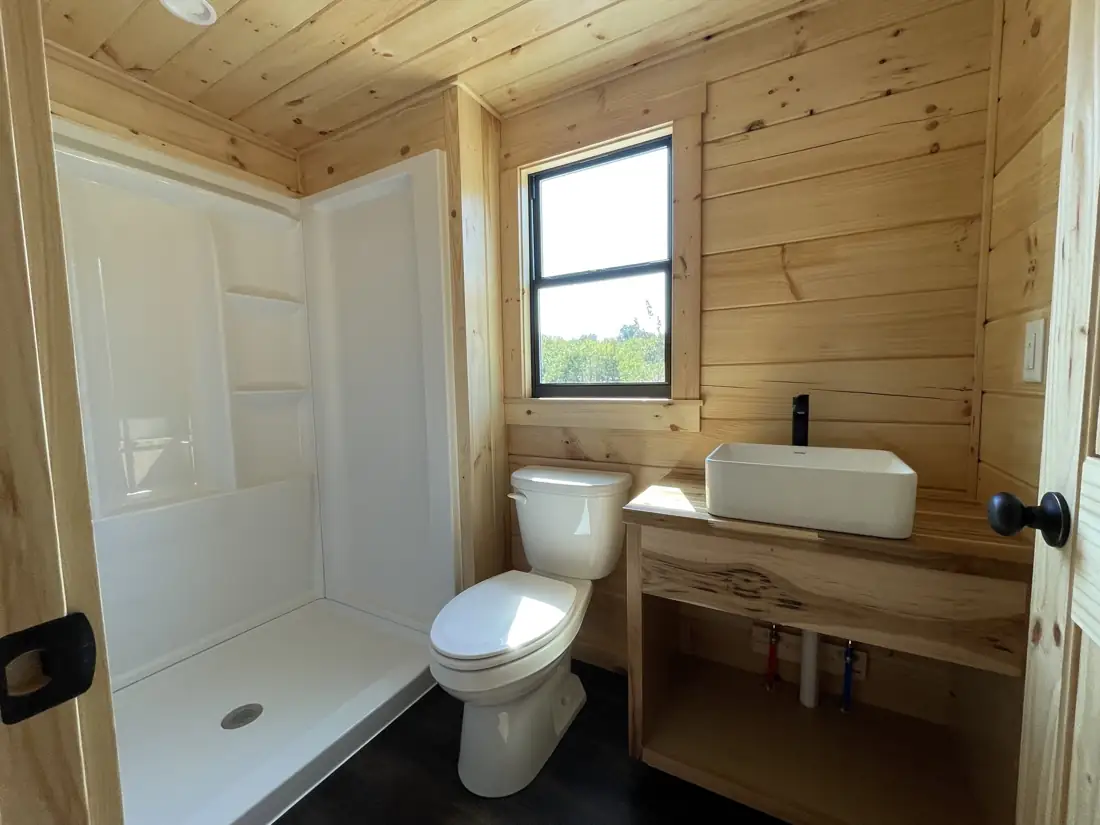 Kodiak bathroom with shower, toilet and vessel sink vanity