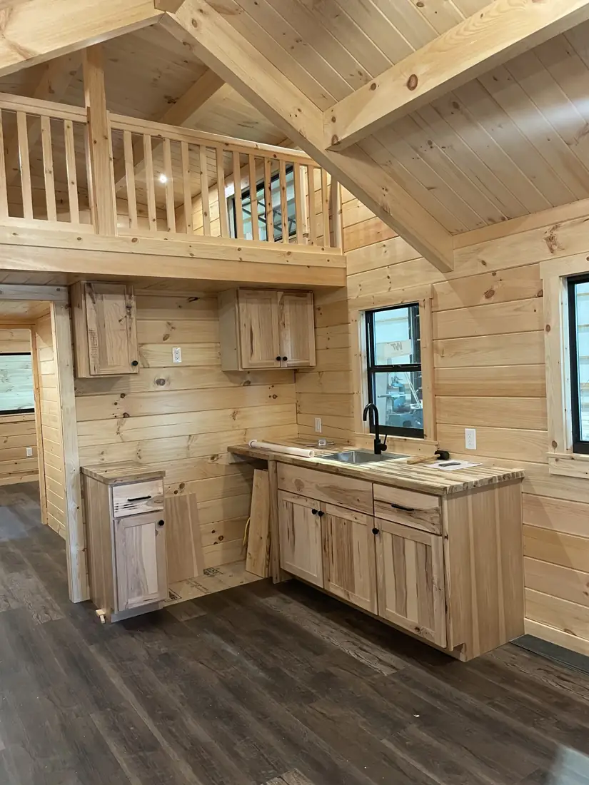 Kitchen under the loft with hickory cabinets and a window
