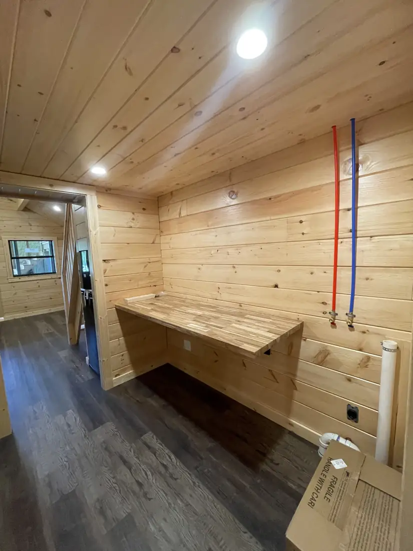 Laundry nook with a long butcher-block counter and hookups