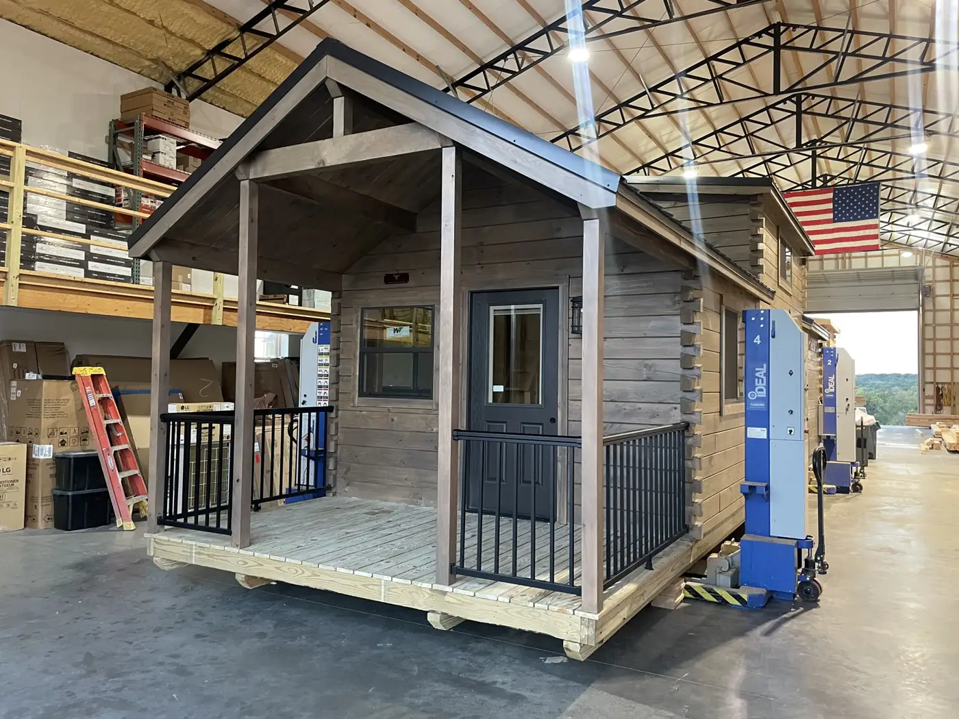 The Kodiak being finished inside the Premium Structures shop under an American flag