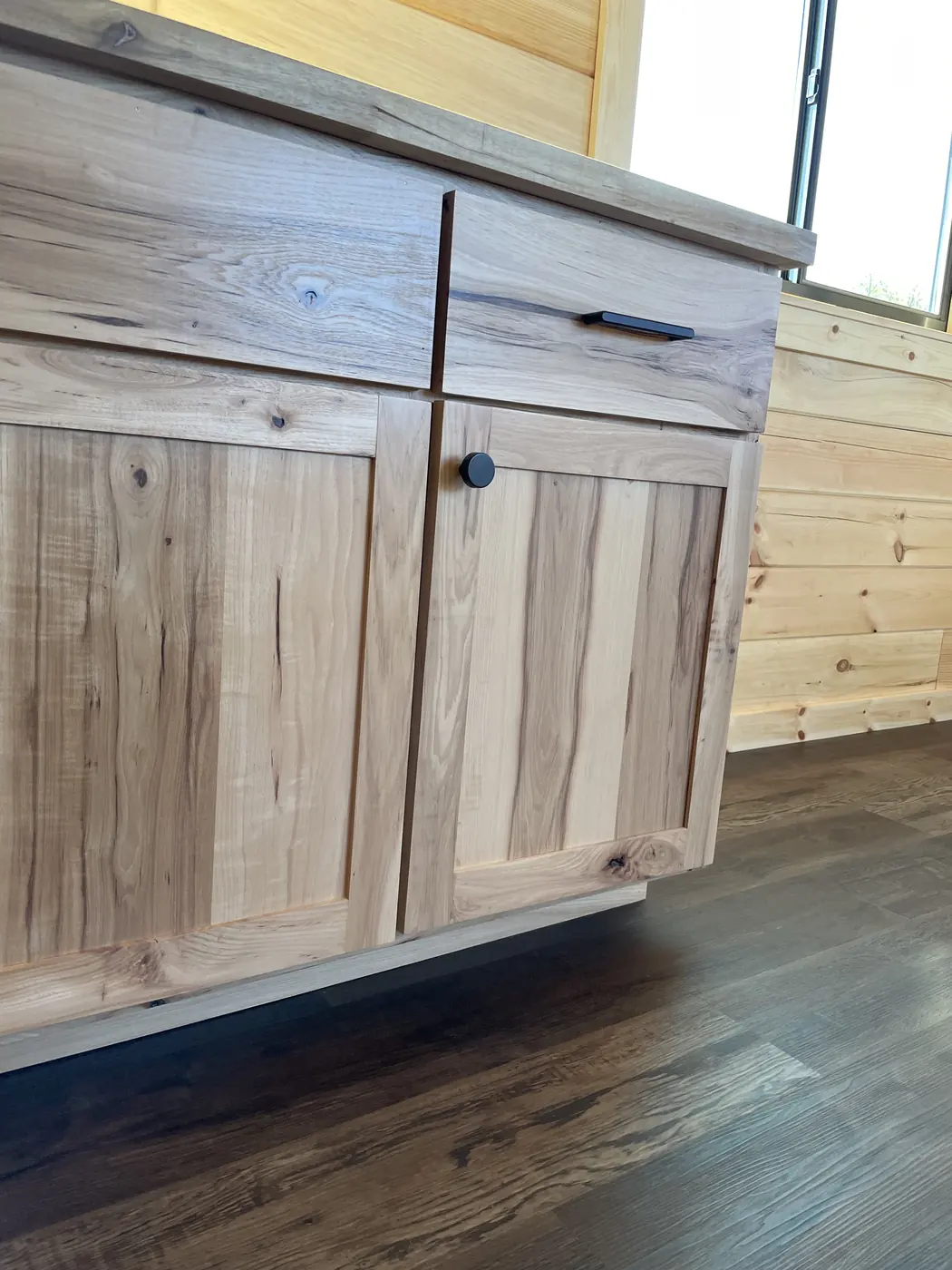 Hickory kitchen cabinet with black hardware
