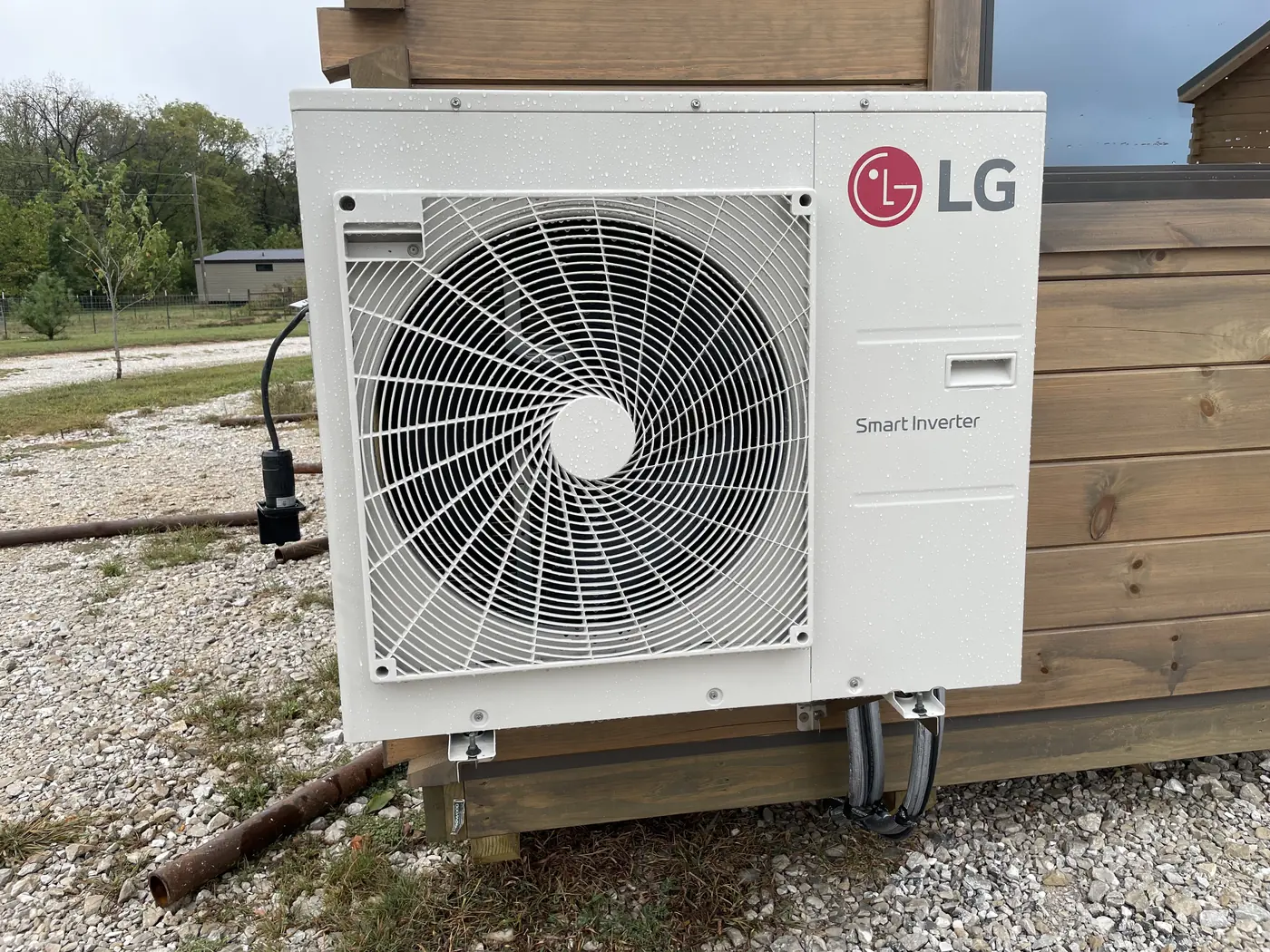 LG mini-split outdoor unit mounted beside the cabin