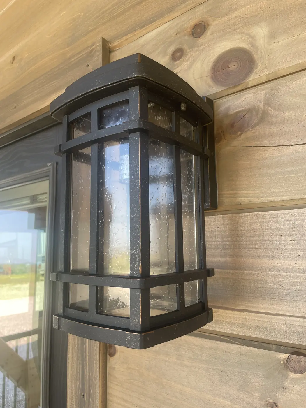Close-up of the finished exterior logs beside the porch light