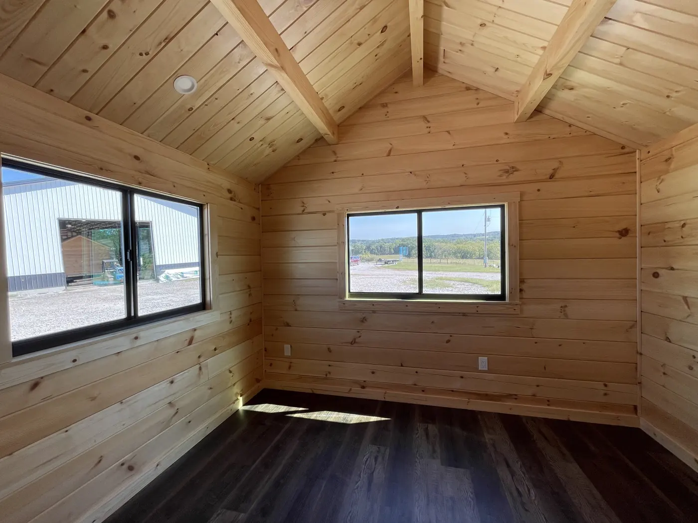 Black-framed windows in the cabin's pine walls