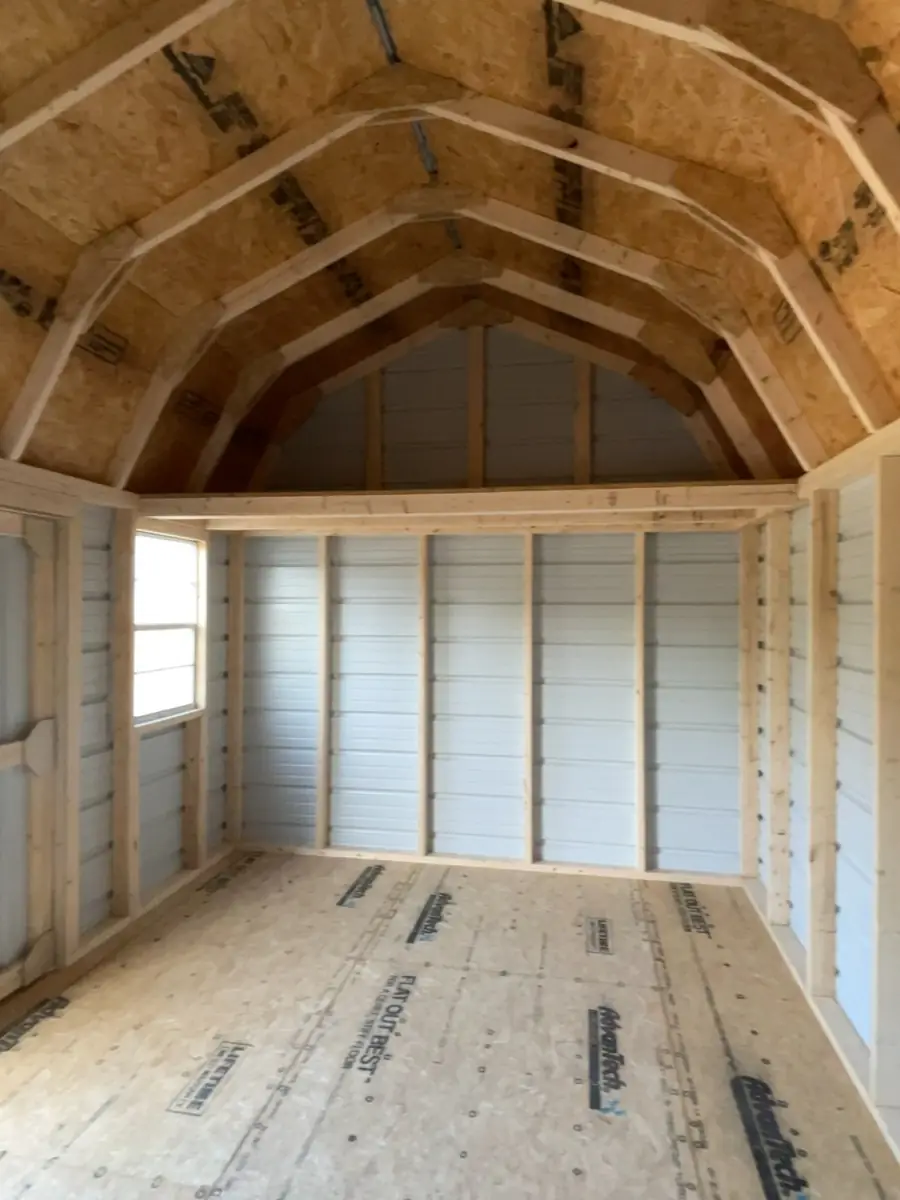 Inside a lofted barn with a gambrel roof, overhead lofts and an open floor
